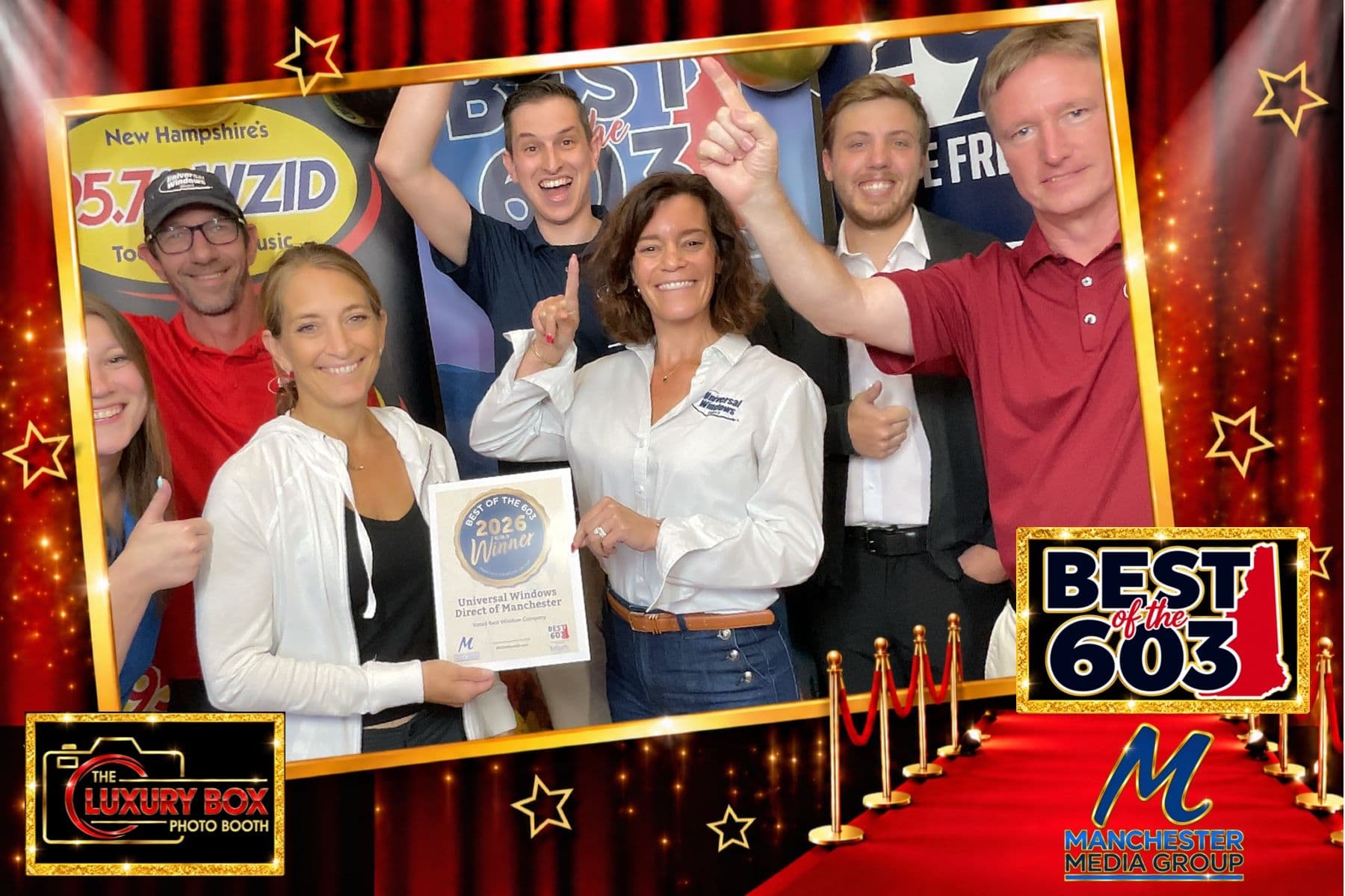 Universal Windows Direct Manchester team members at Best of the 603 awards event holding a Best of the Year award certificate for Universal Windows Direct of Manchester, with red curtain and gold frame backdrop