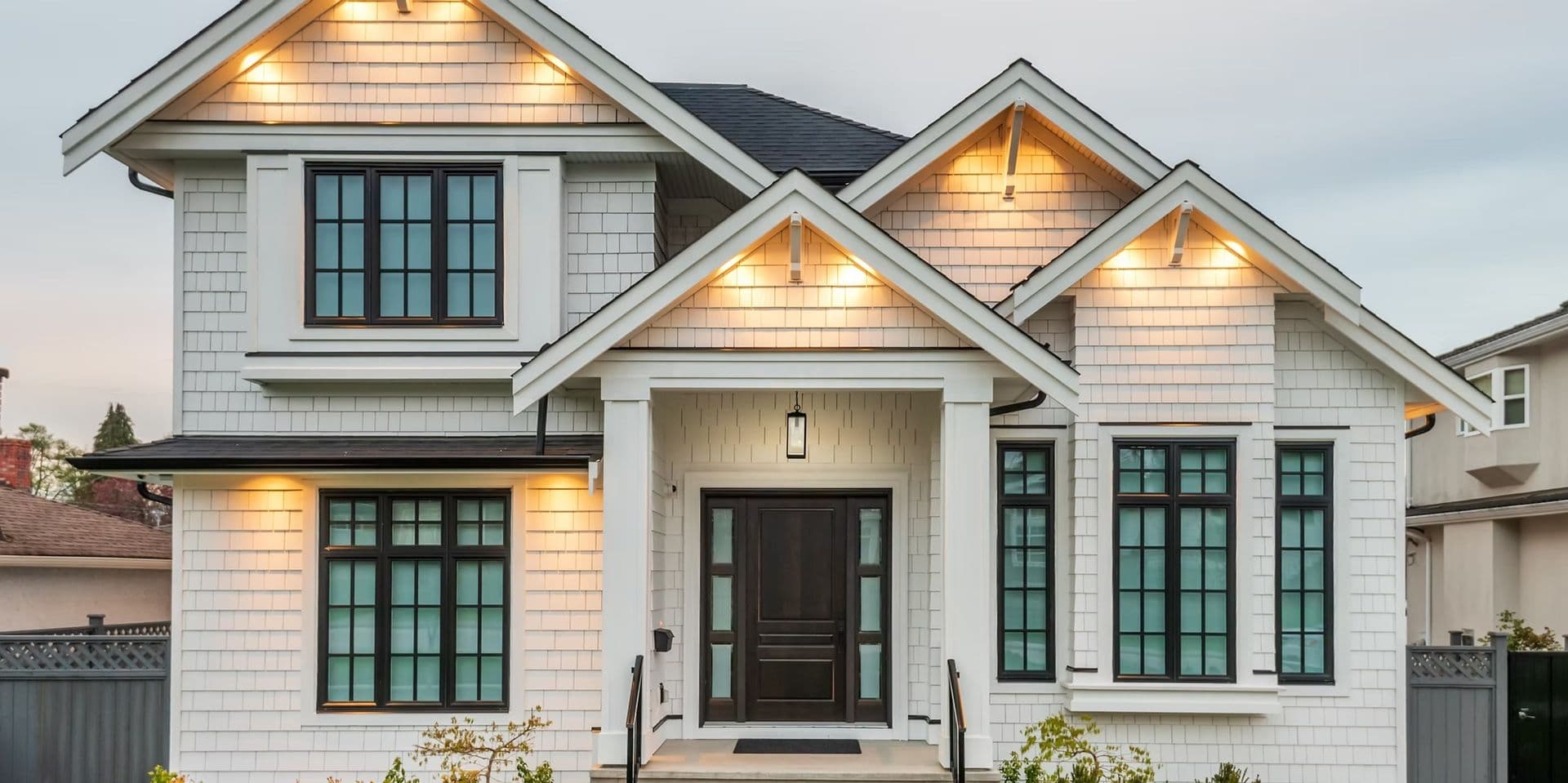 white shakes with architeturial bronze windows